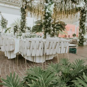 Stunning outdoor wedding setup with lush floral arrangements and elegant table settings, perfect for celebrations.