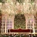 Elegant wedding venue with floral decor, arched windows, and plush furniture. Ideal for lavish events.